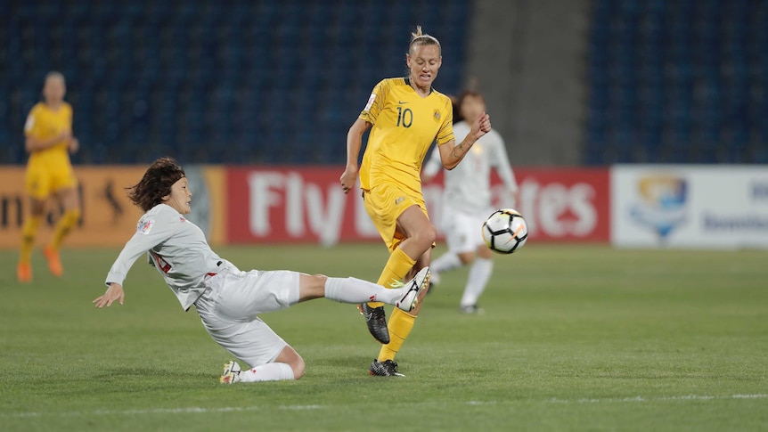 Emily van Egmond gets past a tackle against Japan