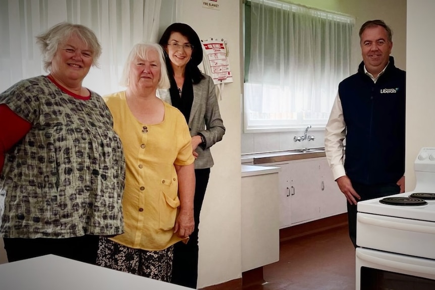 Nic Street and Jacquie Petrusma with CWA representatives in a kitchen.