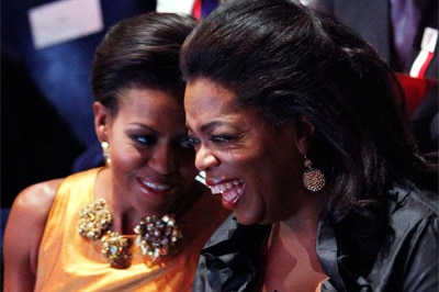 Oprah Winfrey sits with US first lady Michelle Obama at the opening Ceremony of the 121st IOC Session at the Copenhagen Opera...