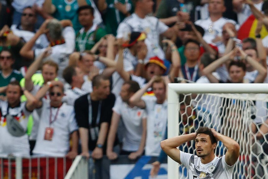 Germany's Mats Hummels reacts along with Germany fans after Germany's loss to Mexico