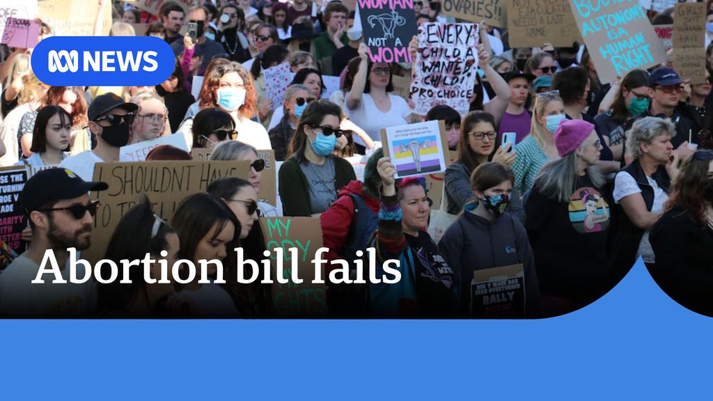 Abortion bill fails: Protesters wear masks and hold signs during a rally. 