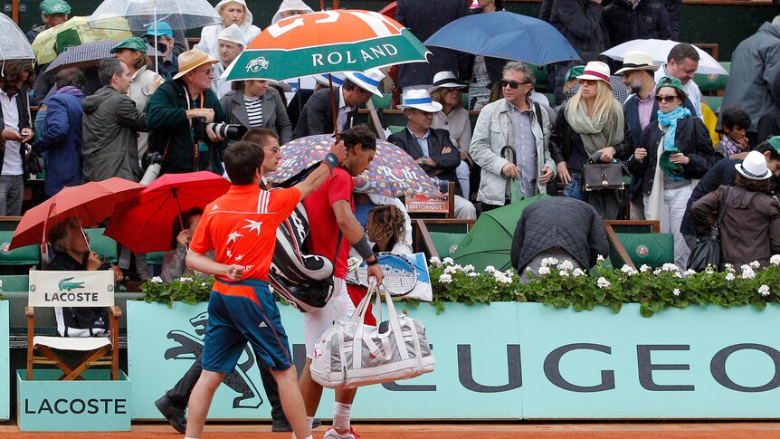Rain delay ... Rafael Nadal trudges off after the final was postponed.