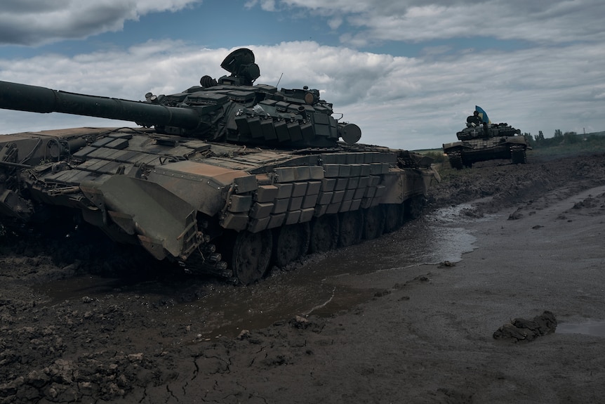 Ukraine tanks on the side of a road. 