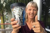 Gympie resident Elli Webb holds a jar that contains a year's worth of her household waste.