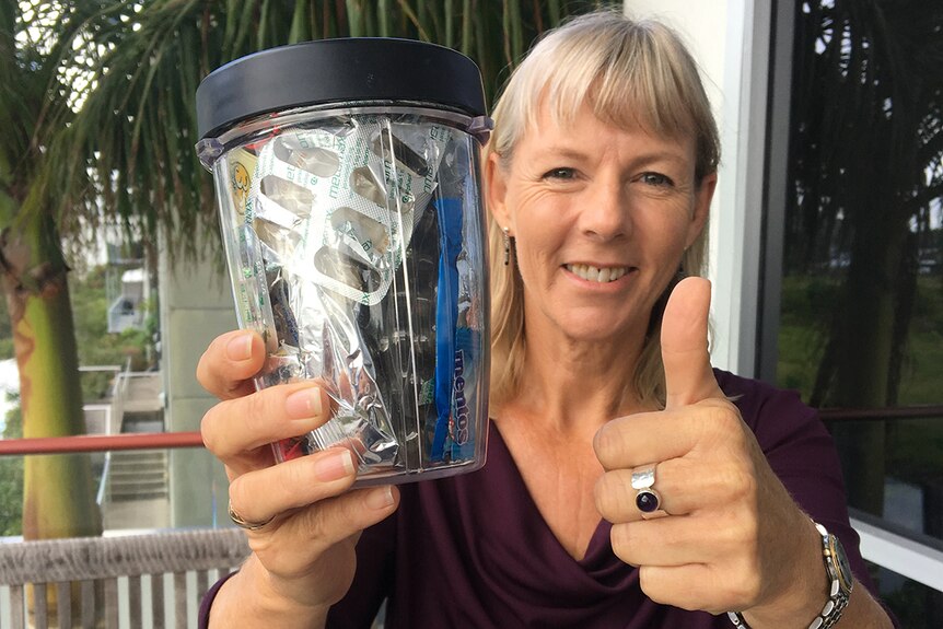 Gympie resident Elli Webb holds a jar that contains a year's worth of her household waste.
