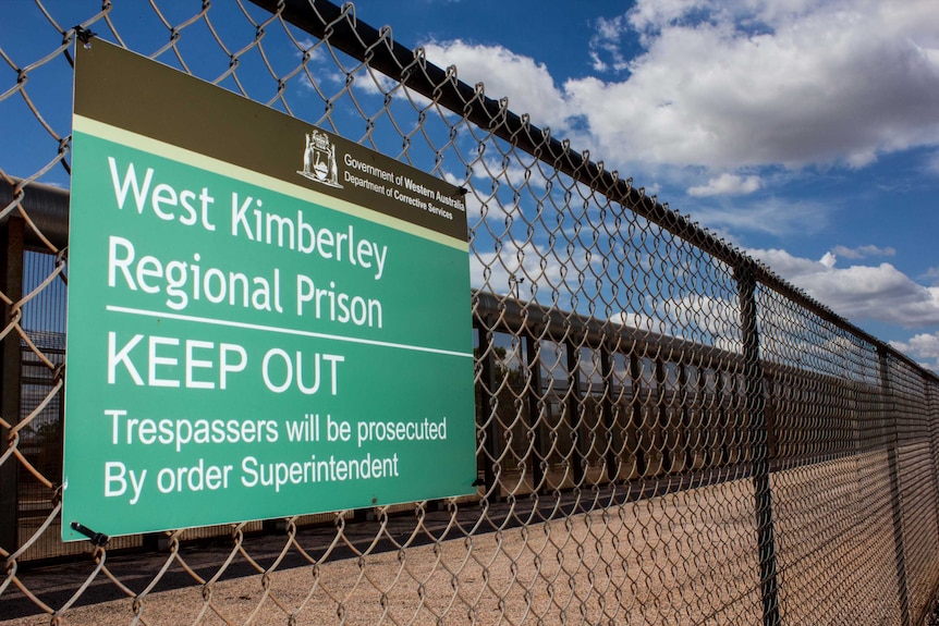 West Kimberley Regional Prison sign saying 'keep out' on a fence.