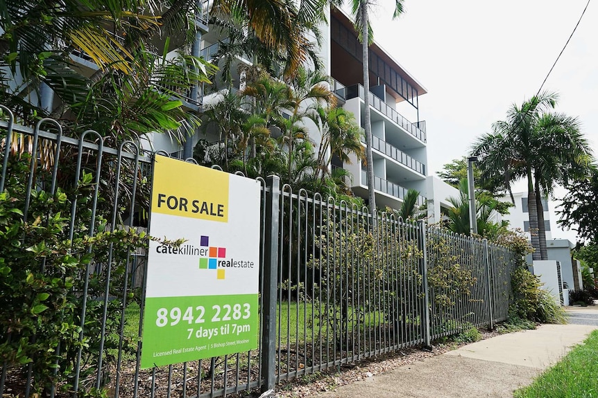 A for sale sign outside apartments in Darwin.