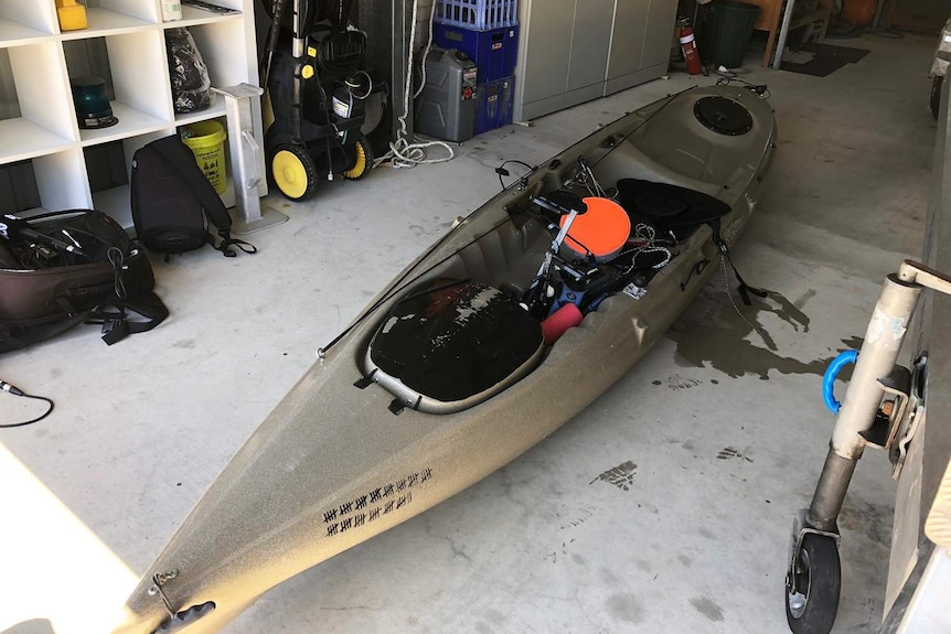 Kayak laying on ground in a shed, which was bitten by a 4 metre tiger shark.