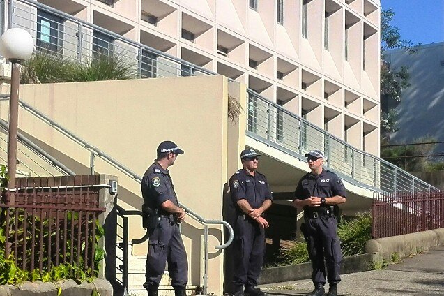 Police officers stand guard outside Newcastle District Court