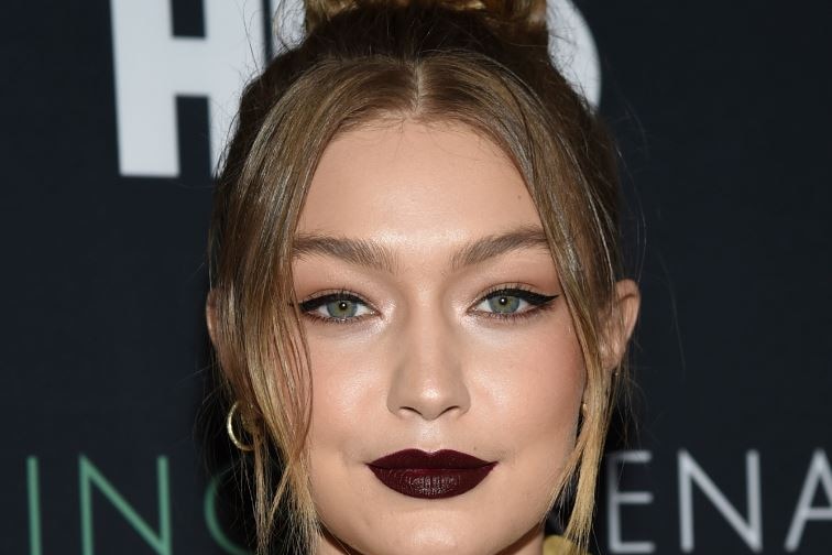 Blonde model Gigi Hadid is seen posing for a photo at an HBO film premiere.