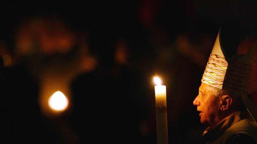 Pope Benedict XVI holds a candle during the Easter vigil mass.