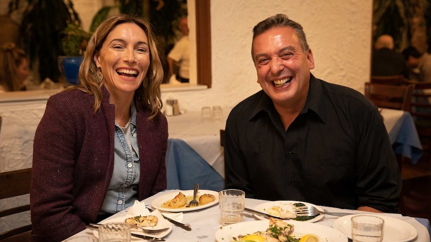 Actor Claudia Karvan and author Christos Tsiolkas smiling, sitting at a restaurant table