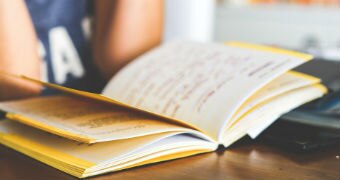 A student studying with an open book.