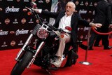 Stan Lee arrives at the 2012 premiere of The Avengers on a motorbike.
