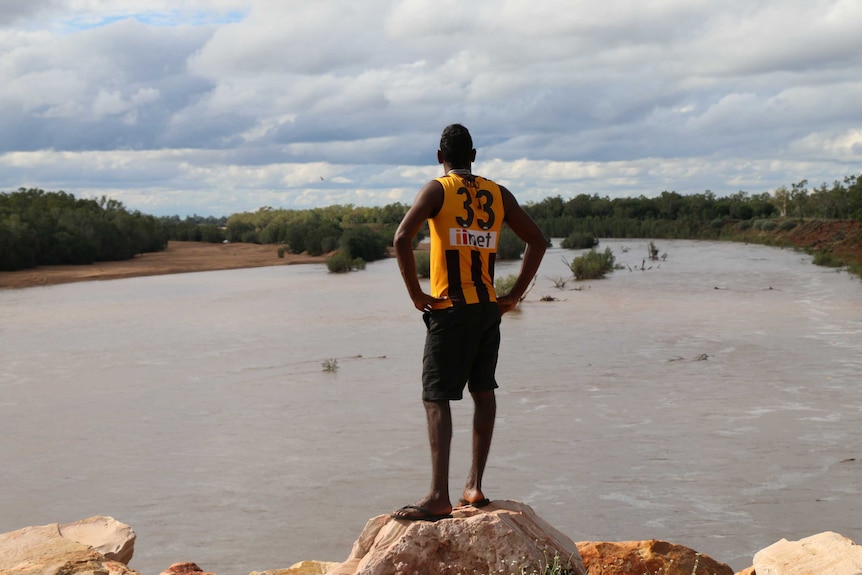 A young man looks out over the Fitzroy River in the Kimberley