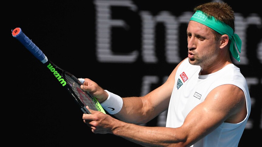 Tennys Sandgren holds his tennis racket the wrong way around during his Australian Open quarter-final against Roger Federer.