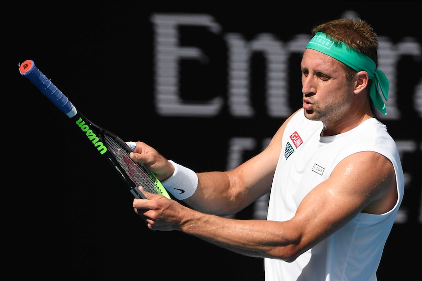 Tennys Sandgren holds his tennis racket the wrong way around during his Australian Open quarter-final against Roger Federer.