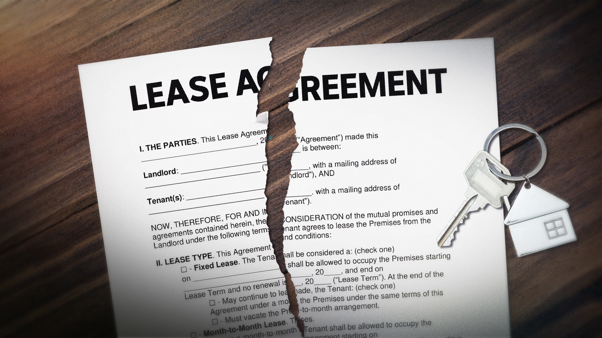 Ripped lease agreement with keys on table