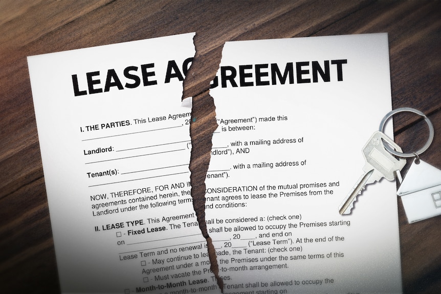 Ripped lease agreement with keys on table