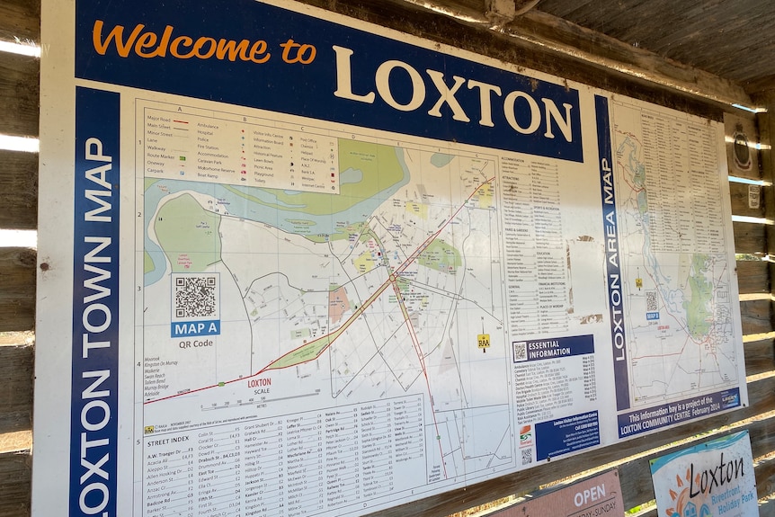 A sign reads 'Welcome to Loxton' a Sprawling town map is pictured, hung in a wooden hut