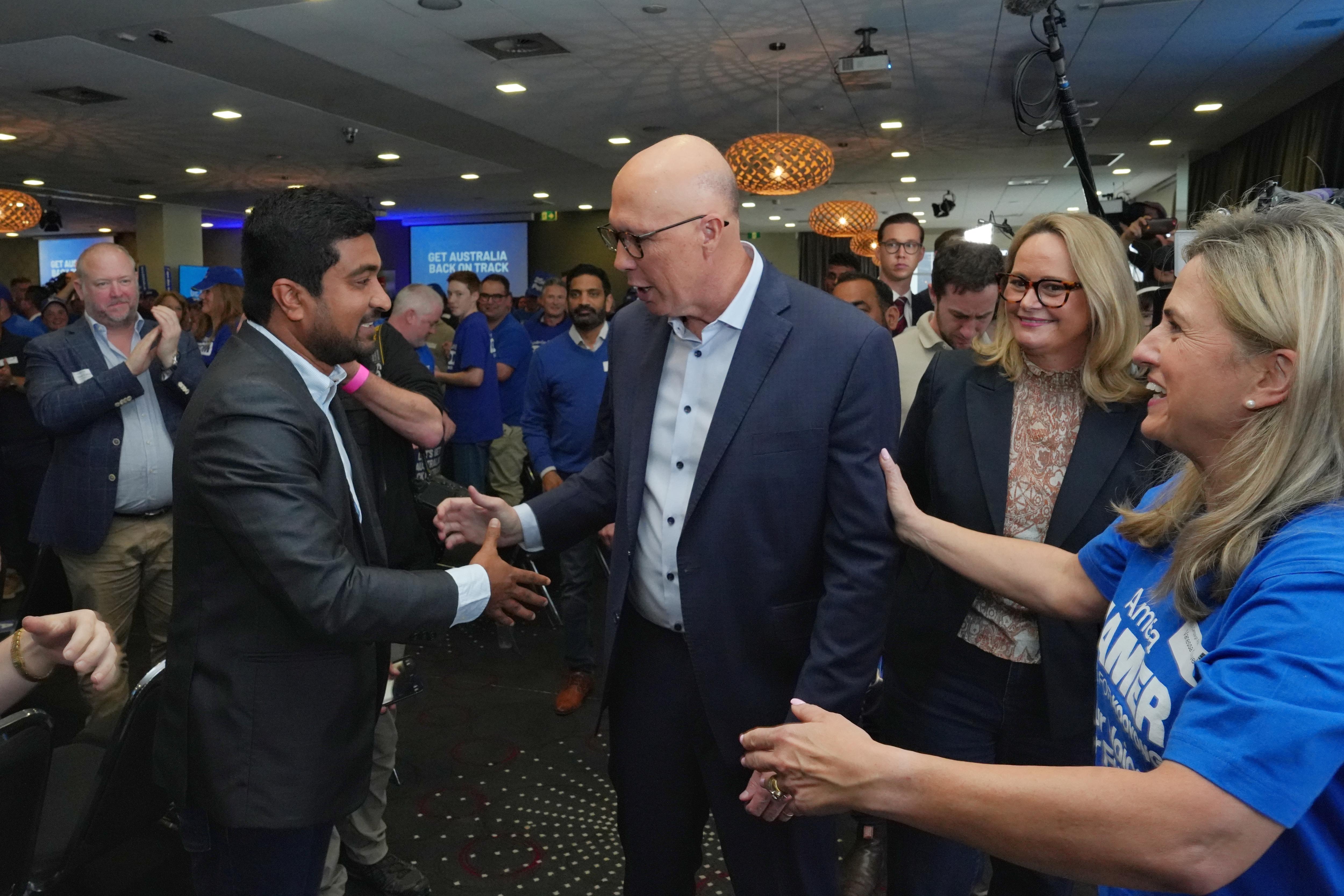 Dutton shakes a man's hand