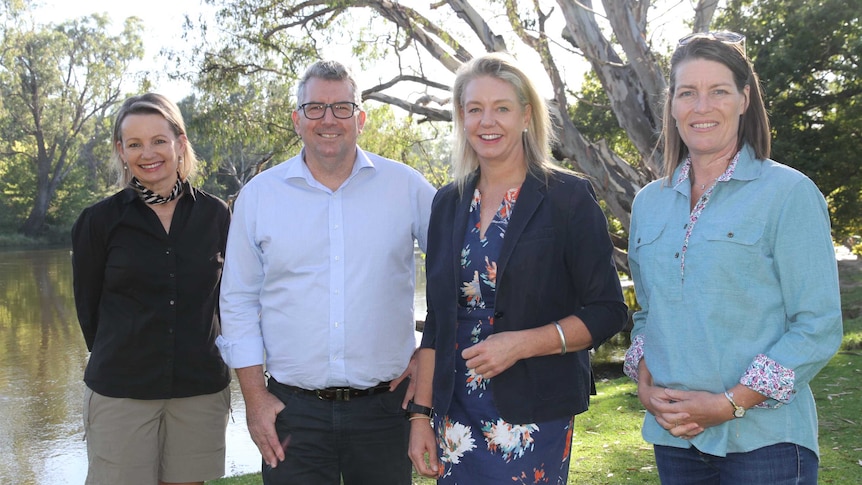 Ministers and Senators standing side by side at the Murray River in Albury