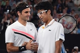 Roger Federer (L) is congratulated by Hyeon Chung after the South Korean retired injured in their semi-final.