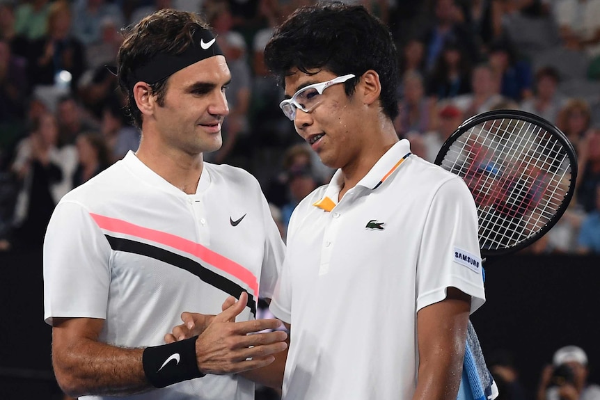 Roger Federer (L) is congratulated by Hyeon Chung after the South Korean retired injured in their semi-final.