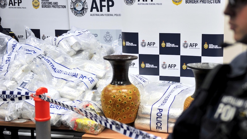 Australian Federal Police officers stand guard next to a seizure of the drugs in Sydney.