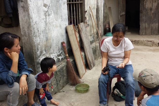 An archaeologist shows their findings to others in Vietnam.