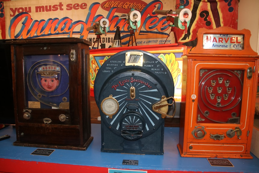 Three old penny arcade machines on display in the museum