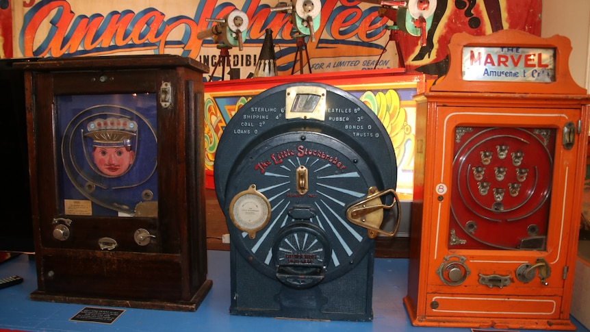 Three old penny arcade machines on display in the museum