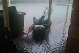 Huge puddle of rain pooling in a home's verandah.