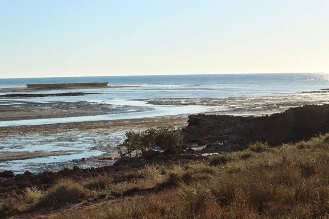 A rock shelf at a vast WA beach.