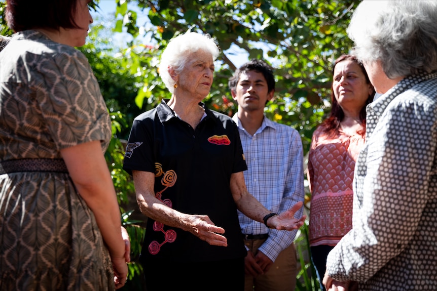 A wide shot of Fiona Stanley talking to a group of people 