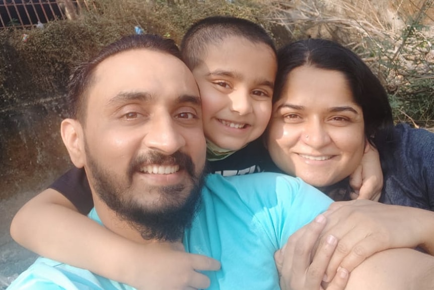 Virendrasinha Bhosale is embraced by his son and wife in this selfie taken after he returned home.