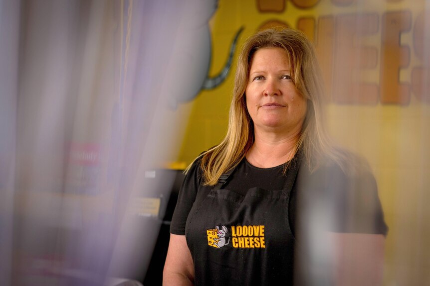 A woman stands in her cheese shop at Mannum in South Australia.