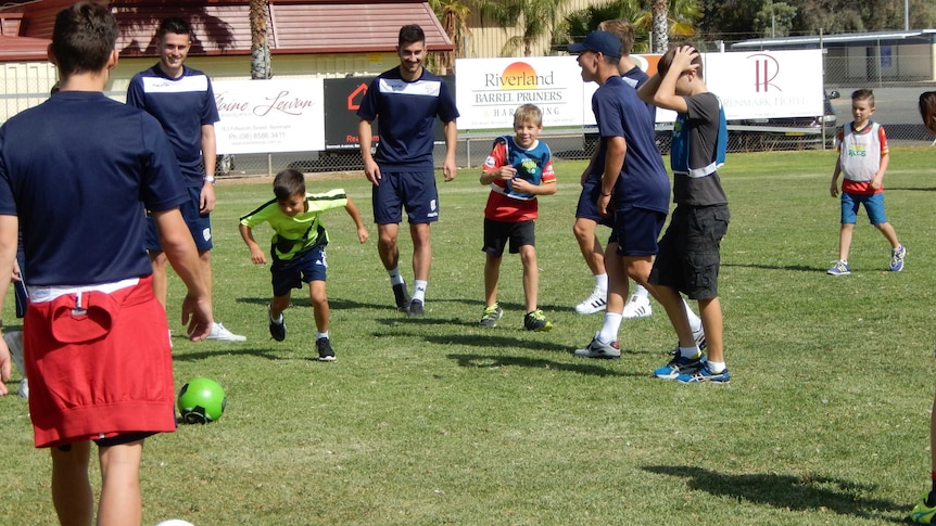 Soccer players host soccer coaching clinics with kids in the Riverland