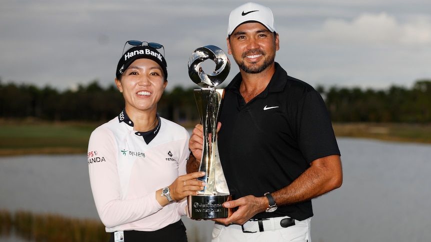 Lydia Ko and Jason Day celebrate with a trophy after winning a mixed teams event.