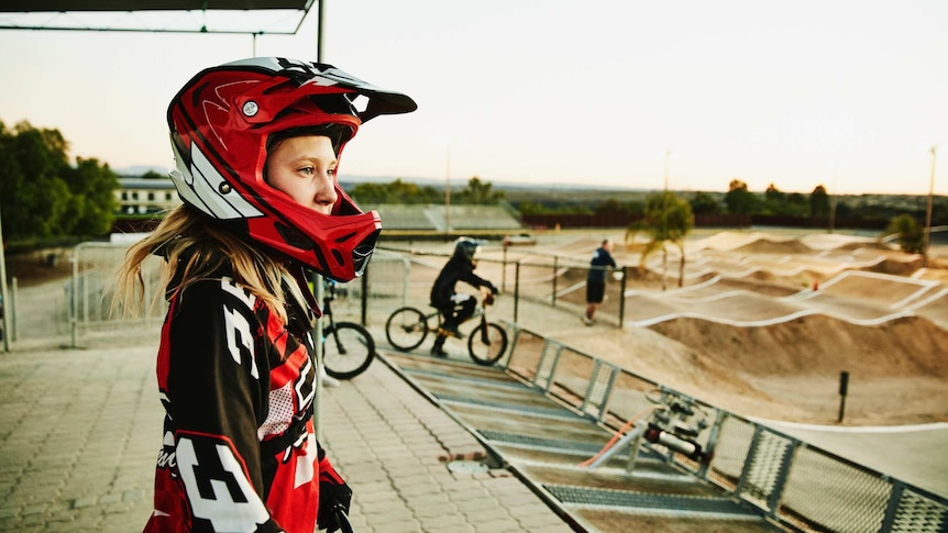 Female BMX racer looking at track before race start