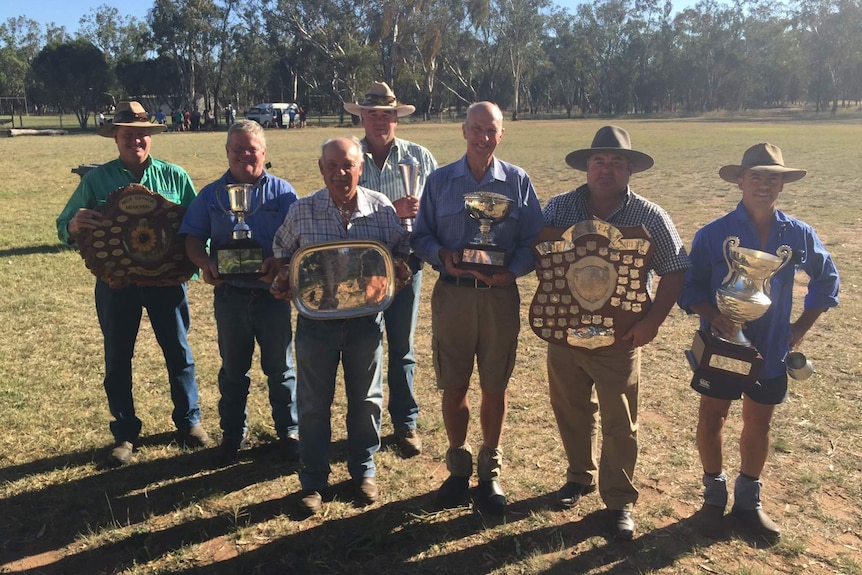 The winners of the 2016 Premer crop competition standing in a line with their shields, trophies and plates