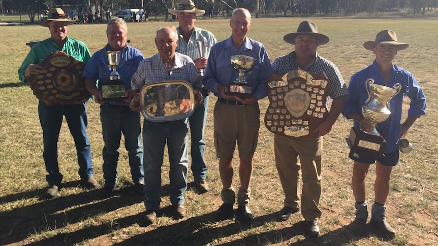 The winners of the 2016 Premer crop competition standing in a line with their shields, trophies and plates
