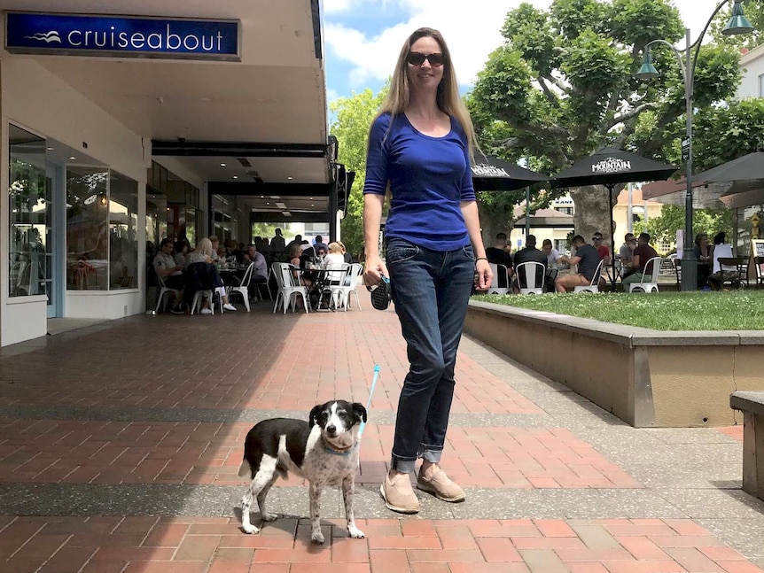 A woman with her dog in Manuka in Canberra.