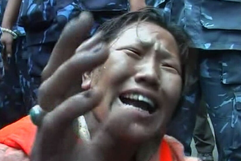 Pro-Tibet demonstrator cries out (Reuters)