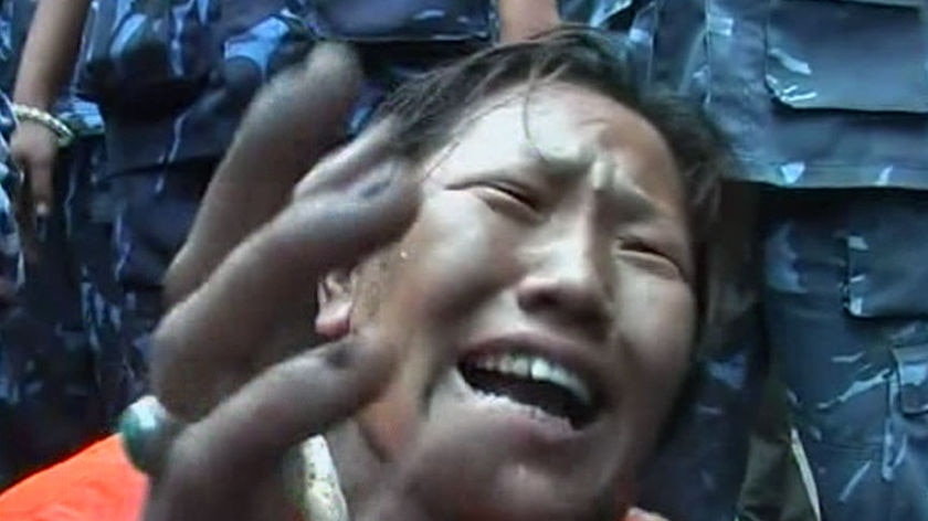 Pro-Tibet demonstrator cries out (Reuters)