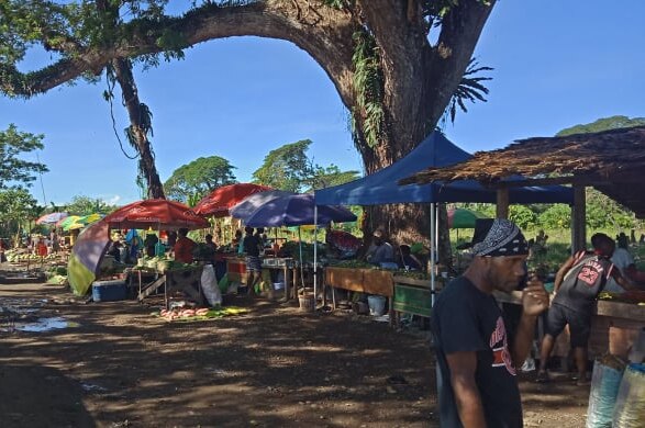 People shop at a roadside market in Honiara, Solomon Islands.