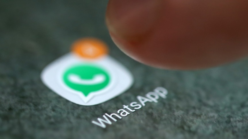 The WhatsApp app logo is seen on a smartphone.