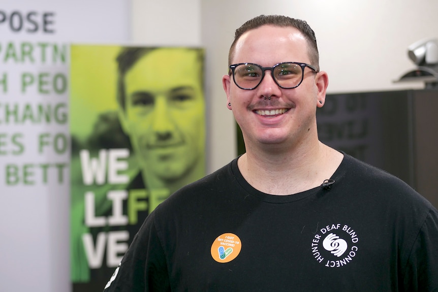 Vaughn Matthews wearing glasses and smiling in a welcoming looking room.