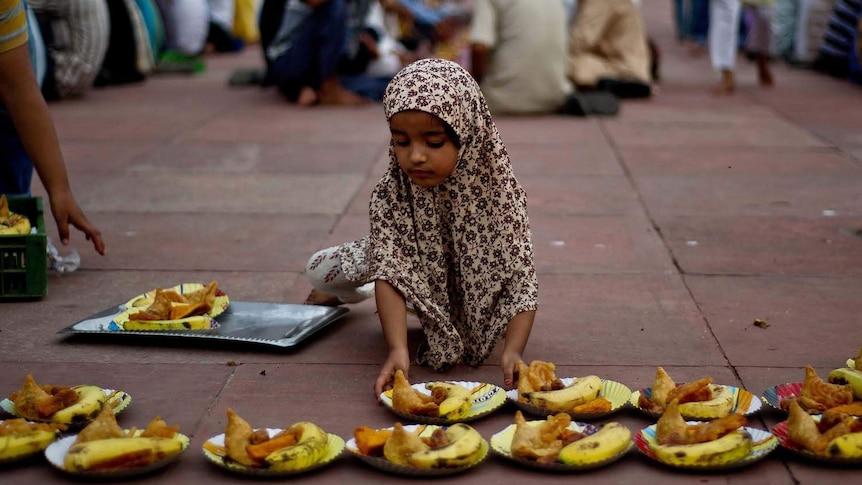 A girl prepares food for the evening meal during Ramadan in India