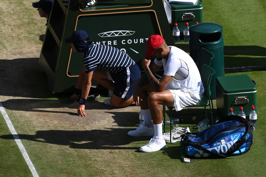 Nick Kyrgios has his head in his hands after losing the Wimbledon final to Novak Djokovic.